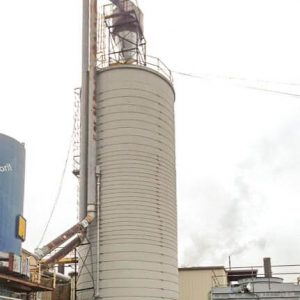 A monolithic concrete silo, used in storing wood shavings.